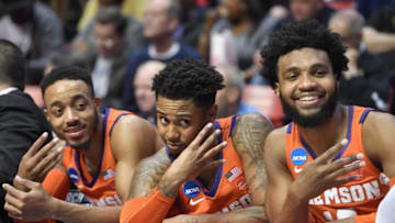 SAN DIEGO, CA - MARCH 18: Marcquise Reed #2, Shelton Mitchell #4 and Gabe DeVoe #10 of the Clemson Tigers celebrate on the bench as they take on the Auburn Tigers in the second half during the second round of the 2018 NCAA Men's Basketball Tournament at Viejas Arena on March 18, 2018 in San Diego, California. The Clemson Tigers won 84-53. (Photo by Donald Miralle/Getty Images)