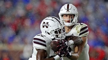 OXFORD, MISSISSIPPI - NOVEMBER 24: Will Rogers #2 of the Mississippi State Bulldogs hands the ball to Simeon Price #22 of the Mississippi State Bulldogs during the second half against the Mississippi Rebels at Vaught-Hemingway Stadium on November 24, 2022 in Oxford, Mississippi. (Photo by Justin Ford/Getty Images)