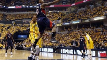 Apr 19, 2014; Indianapolis, IN, USA; Atlanta Hawks guard Jeff Teague (0) takes a shot against Indiana Pacers guard George Hill (3) in game one during the first round of the 2014 NBA Playoffs at Bankers Life Fieldhouse. Mandatory Credit: Brian Spurlock-USA TODAY Sports