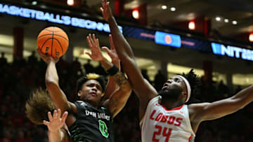 ALBUQUERQUE, NEW MEXICO - MARCH 15: Justin Harmon #0 of the Utah Valley Wolverines is fouled by Josiah Allick #53 of the New Mexico Lobos as Morris Udeze #24 defends during the first half of their first round game in the 2023 National Invitation Tournament at The Pit on March 15, 2023 in Albuquerque, New Mexico. (Photo by Sam Wasson/Getty Images)