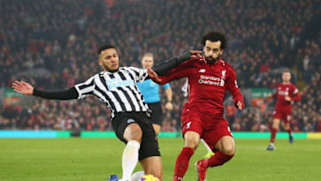 LIVERPOOL, ENGLAND - DECEMBER 26: Mohamed Salah of Liverpool is challenged by Jamaal Lascelles of Newcastle United during the Premier League match between Liverpool FC and Newcastle United at Anfield on December 26, 2018 in Liverpool, United Kingdom. (Photo by Jan Kruger/Getty Images)