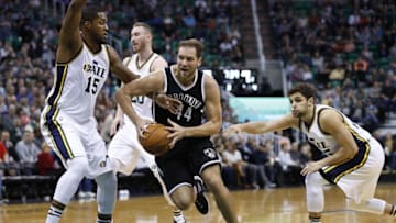 Feb 27, 2016; Salt Lake City, UT, USA; Brooklyn Nets guard Bojan Bogdanovic (44) drives to the hoop against Utah Jazz forward Derrick Favors (15) and guard Raul Neto (25) in the third quarter at Vivint Smart Home Arena. Mandatory Credit: Jeff Swinger-USA TODAY Sports