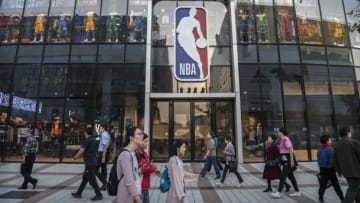 BEIJING, CHINA - OCTOBER 09: People walk by the NBA flagship retail store on October 9, 2019 in Beijing, China. The NBA is trying to salvage its brand in China amid criticism of its handling of a controversial tweet that infuriated the government and has jeopardized the leagues Chinese expansion. The crisis, triggered by a Houston Rockets executives tweet that praised protests in Hong Kong, prompted the Chinese Basketball Association to suspend its partnership with the league. The backlash continued with state-owned television CCTV scrapping its plans to broadcast pre-season games in Shanghai and Shenzhen, and the cancellation of other promotional fan events. The league issued an apology, though NBA Commissioner Adam Silver angered Chinese officials further when he defended the right of players and team executives to free speech. China represents a lucrative market for the NBA, which stands to lose millions of dollars in revenue and threatens to alienate Chinese fans. Many have taken to Chinas social media platforms to express their outrage and disappointment that the NBA would question the countrys sovereignty over Hong Kong which has been mired in anti-government protests since June.(Photo by Kevin Frayer/Getty Images)