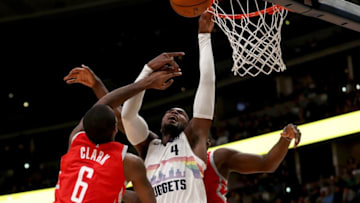 DENVER, CO - NOVEMBER 13: Paul Millsap #4 of the Denver Nuggets is blocked going to the basket by Gary Clark #6 and Clint Capela #15 of the Houston Rockets at the Pepsi Center on November 13, 2018 in Denver, Colorado. NOTE TO USER: User expressly acknowledges and agrees that, by downloading and or using this photograph, User is consenting to the terms and conditions of the Getty Images License Agreement. (Photo by Matthew Stockman/Getty Images)