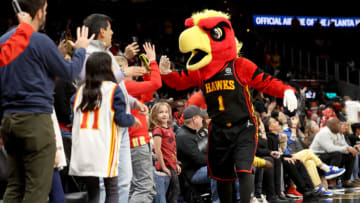 Mar 11, 2022; Atlanta, Georgia, USA; Atlanta Hawks mascot Harry the Hawk high fives fans during the second half against the LA Clippers at State Farm Arena. Mandatory Credit: Jason Getz-USA TODAY Sports