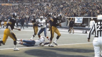 PITTSBURGH, PA - DECEMBER 22: Running back Franco Harris #32 of the Pittsburgh Steelers scores a touchdown against the Buffalo Bills during the AFC Divisional Playoffs December 22, 1974 at Three Rivers Stadium in Pittsburgh, Pennsylvania. Harris played for the Steelers from 1972-83. (Photo by Focus on Sport/Getty Images)