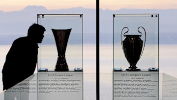 A man looks at the UEFA Europa cup troph