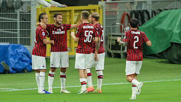 Milan celebrate their opening goal against Atalanta