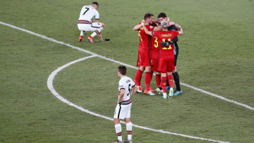 Belgium's players celebrate with Cristiano Ronaldo distraught in the background