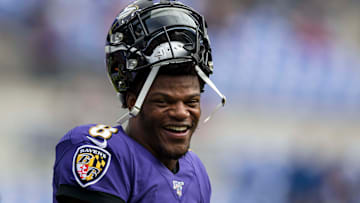 Ravens quarterback Lamar Jackson smiles with his helmet off during a game against the Bengals.