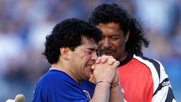 Colombian goalie Rene Higuita (R) consoles former