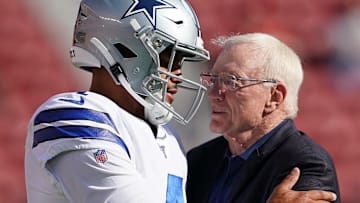 Dak Prescott (left), talking to Jerry Jones (right)