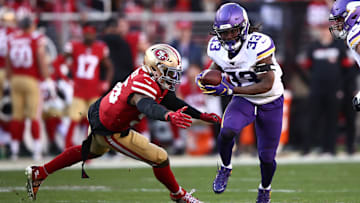 Vikings running back Dalvin Cook, right, evades a tackle at the knees during a Divisional Round loss to the 49ers.