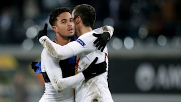 Henrikh Mkhitaryan embraces Justin Kluivert