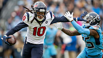 Texans wideout De'Andre Hopkins stiff-arming a Titans defender 