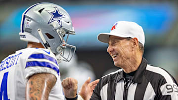 The Cowboys QB conversing before a game vs. the Jaguars with a referee
