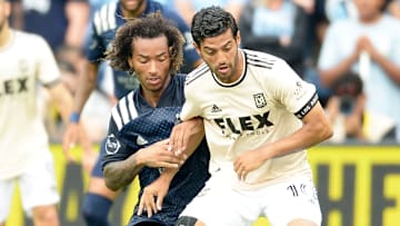 Gianluca Busio del Sporting Kansas City y Carlos Vela de LAFC compiten por la posesión del esférico.