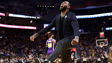 LeBron James celebrating on the bench during Lakers-Warriors