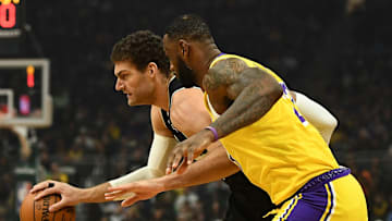 LeBron James covering the Bucks' Brook Lopez in the Lakers' loss on Thursday.