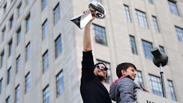 New England Patriots quarterback Tom Brady hoists the Vince Lombardi trophy in after winning his sixth Super Bowl in 2019