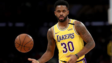 Lakers guard Troy Daniels hands the ball off to a teammate against the Knicks.