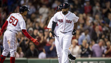Red Sox outfielders Mookie Betts and Jackie Bradley Jr. high five as JBJ trots towards home