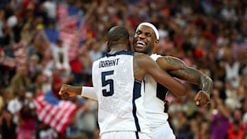 LeBron James, right, bumps chests with Kevin Durant.