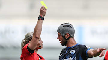 Klaus Gjasula receiving a booking