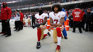 Quarterback Colin Kaepernick and linebacker Eli Harold take a knee during the national anthem at a game in 2016.