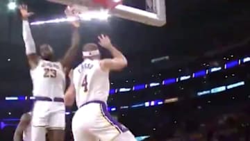 Los Angeles Lakers forward LeBron James pretends to try to block Alex Caruso's dunk attempt.