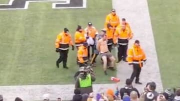 XFL fan streaks on the field during New York Guardians first home game.