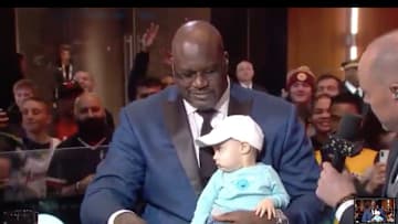Shaq conducting an Interview with a baby during All-Star weekend