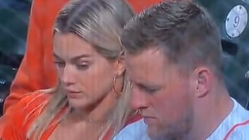 JJ Watt's fiancee, Kealia Ohai, keeps a keen eye on his phone during World Series Game 1.