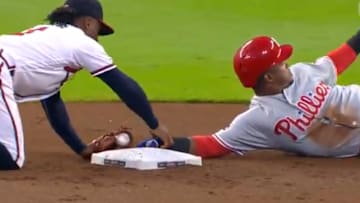 Ozzie Albies takes Jean Segura's hand off bag after stolen base on Wednesday.