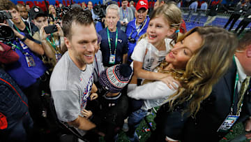 Tom Brady celebrating with his family on the field after the Patriots' Super Bowl LIII win.