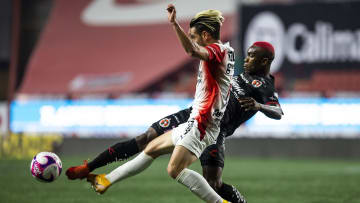 Jesús Angulo pelea un balón ante Fabián Castillo.