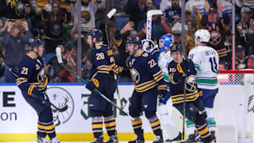 BUFFALO, NY - JANUARY 11: Zemgus Girgensons #28 of the Buffalo Sabres celebrates his game tying goal with Kyle Okposo #21, Johan Larsson #22, and Henri Jokiharju #10. Girgensons goal tied the game at 3-3 with 17:32 remaining in the 3rd period of play the NHL hockey game between the Vancouver Canucks and Buffalo Sabres at KeyBank Center on January 11, 2020 in Buffalo, New York. (Photo by Nicholas T. LoVerde/Getty Images)