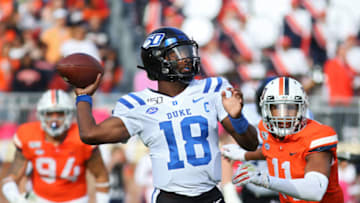CHARLOTTESVILLE, VA - OCTOBER 19: Quentin Harris #18 of the Duke Blue Devils throws a pass under pressure from Charles Snowden #11 of the Virginia Cavaliers in the first half during a game at Scott Stadium on October 19, 2019 in Charlottesville, Virginia. (Photo by Ryan M. Kelly/Getty Images)