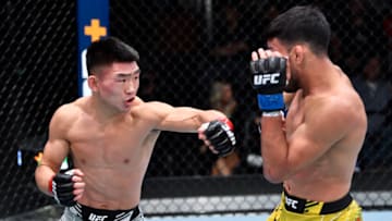LAS VEGAS, NEVADA - NOVEMBER 13: (L-R) Song Yadong of China punches Julio Arce in a bantamweight fight during the UFC Fight Night event at UFC APEX on November 13, 2021 in Las Vegas, Nevada. (Photo by Chris Unger/Zuffa LLC)