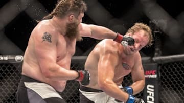 Feb 6, 2016; Las Vegas, NV, USA; Roy Nelson (red gloves) fights against Jared Rosholt (blue gloves) during UFC Fight Night at MGM Grand Garden Arena. Mandatory Credit: Joshua Dahl-USA TODAY Sports