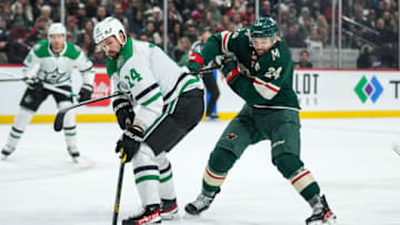 Nov 18, 2021; Saint Paul, Minnesota, USA; Dallas Stars forward Jamie Benn (14) is hooked by Minnesota Wild defenseman Mathew Dumba (24) during the first period at Xcel Energy Center. Mandatory Credit: Brace Hemmelgarn-USA TODAY Sports