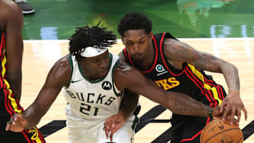 MILWAUKEE, WISCONSIN - JULY 01: Jrue Holiday #21 of the Milwaukee Bucks steals the ball form Lou Williams #6 of the Atlanta Hawks during the first half in Game Five of the Eastern Conference Finals at Fiserv Forum on July 01, 2021 in Milwaukee, Wisconsin. NOTE TO USER: User expressly acknowledges and agrees that, by downloading and or using this photograph, User is consenting to the terms and conditions of the Getty Images License Agreement. (Photo by Stacy Revere/Getty Images)