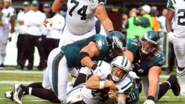 Sep 27, 2015; East Rutherford, NJ, USA; New York Jets quarterback Ryan Fitzpatrick (14) is tackled by Philadelphia Eagles linebacker Connor Barwin (98) and Eagles defensive tackle Beau Allen (94) and linebacker Jordan Hicks (58) during the fourth quarter at MetLife Stadium. Mandatory Credit: Brad Penner-USA TODAY Sports