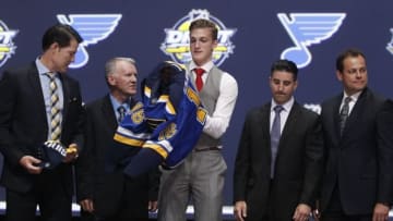 Jun 24, 2016; Buffalo, NY, USA; Tage Thompson puts on a team jersey after being selected as the number twenty-six overall draft pick by the St. Louis Blues in the first round of the 2016 NHL Draft at the First Niagra Center. Mandatory Credit: Timothy T. Ludwig-USA TODAY Sports