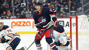 Nov 16, 2021; Winnipeg, Manitoba, CAN; Winnipeg Jets forward Riley Nash (20) screens Edmonton Oilers goalie Mikko Koskinen (19) during the second period at Canada Life Centre. Mandatory Credit: Terrence Lee-USA TODAY Sports