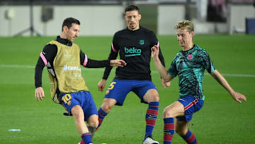 (FromL) Barcelona's Argentine forward Lionel Messi, Barcelona's French defender Clement Lenglet and Barcelona's Dutch midfielder Frenkie De Jong warm up before the UEFA Champions League football match between FC Barcelona and Ferencvarosi TC at the Camp Nou stadium in Barcelona on October 20, 2020. (Photo by LLUIS GENE / AFP) (Photo by LLUIS GENE/AFP via Getty Images)