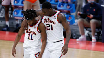 Illinois Fighting Illini guard Ayo Dosunmu (11) is comforted by Illinois Fighting Illini center Kofi Cockburn (21) in the second half during the second round of the 2021 NCAA Tournament on Sunday, March 21, 2021, at Bankers Life Fieldhouse in Indianapolis, Ind. Mandatory Credit: Alton Strupp/IndyStar via USA TODAY Sports