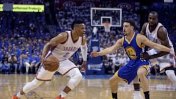 May 22, 2016; Oklahoma City, OK, USA; Oklahoma City Thunder guard Russell Westbrook (0) dribbles as Golden State Warriors guard Klay Thompson (11) defends during the first quarter in game three of the Western conference finals of the NBA Playoffs at Chesapeake Energy Arena. Mandatory Credit: Mark D. Smith-USA TODAY Sports
