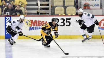 May 30, 2016; Pittsburgh, PA, USA; Pittsburgh Penguins center Sidney Crosby (87) skates with the puck between San Jose Sharks center Patrick Marleau (12) and defenseman Brent Burns (88) in the second period in game one of the 2016 Stanley Cup Final at Consol Energy Center. Mandatory Credit: Don Wright-USA TODAY Sports