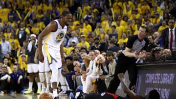 OAKLAND, CALIFORNIA - APRIL 13: Kevin Durant #35 of the Golden State Warriors has words with Patrick Beverley #21 of the LA Clippers during Game One of the first round of the 2019 NBA Western Conference Playoffs at ORACLE Arena on April 13, 2019 in Oakland, California. Both players were ejected after the play. NOTE TO USER: User expressly acknowledges and agrees that, by downloading and or using this photograph, User is consenting to the terms and conditions of the Getty Images License Agreement. (Photo by Ezra Shaw/Getty Images)